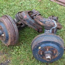 Car parts lined up at a swap meet