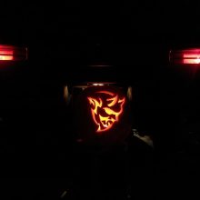 Dodge Demon pumpkin in front of the back end of a Dodge Demon
