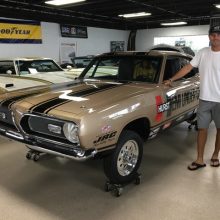 Chris Jacobs standing next to Hurst HEMI Under Glass