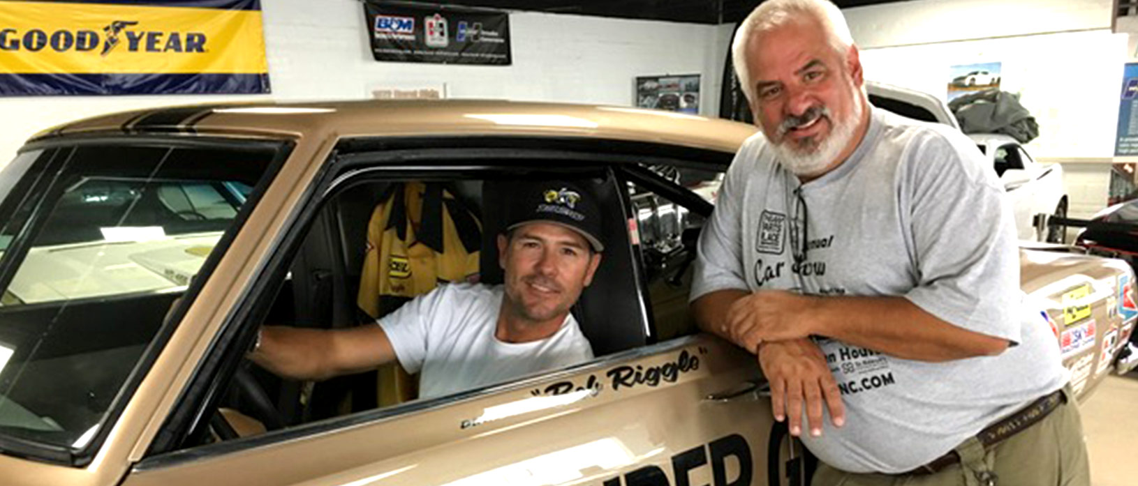 Joe Spagnoli posing with Chris Jacobs in front of fully restored HEMI Under Glass 1969 Barracuda