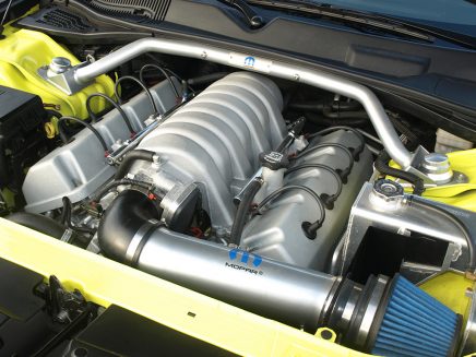 Adorned with a Mopar Performance cold air kit and strut tower brace, the original 6.1-liter HEMI® was bored and stroked to a full 426 cubes. The fabricated Moroso coolant reservoir adds drag strip pit vibes.