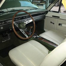 The standard GTS interior was far more inviting than the sparse void of typical Dodge Package Cars. This one has the optional wood-grain sport steering wheel, a $26.75 upcharge. Unlike the 150 mph speedometer used in 440 Magnum-powered Chargers and Coronets, the standard 120 mph Dart speedometer was retained aboard every 440 GTS. The optional ($50.15) console-mounted 6,000 rpm tachometer looks great but is too low for easy use.