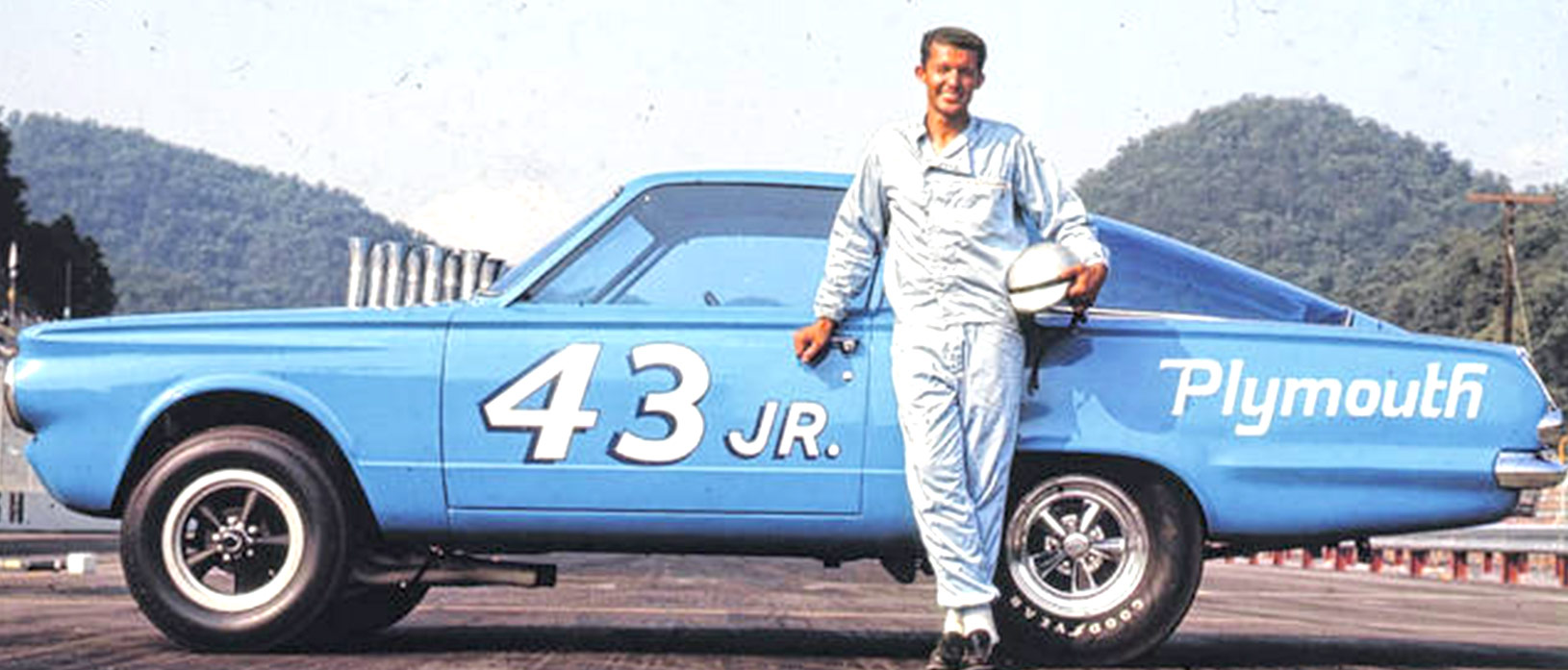 Richard Petty standing in front of his race car