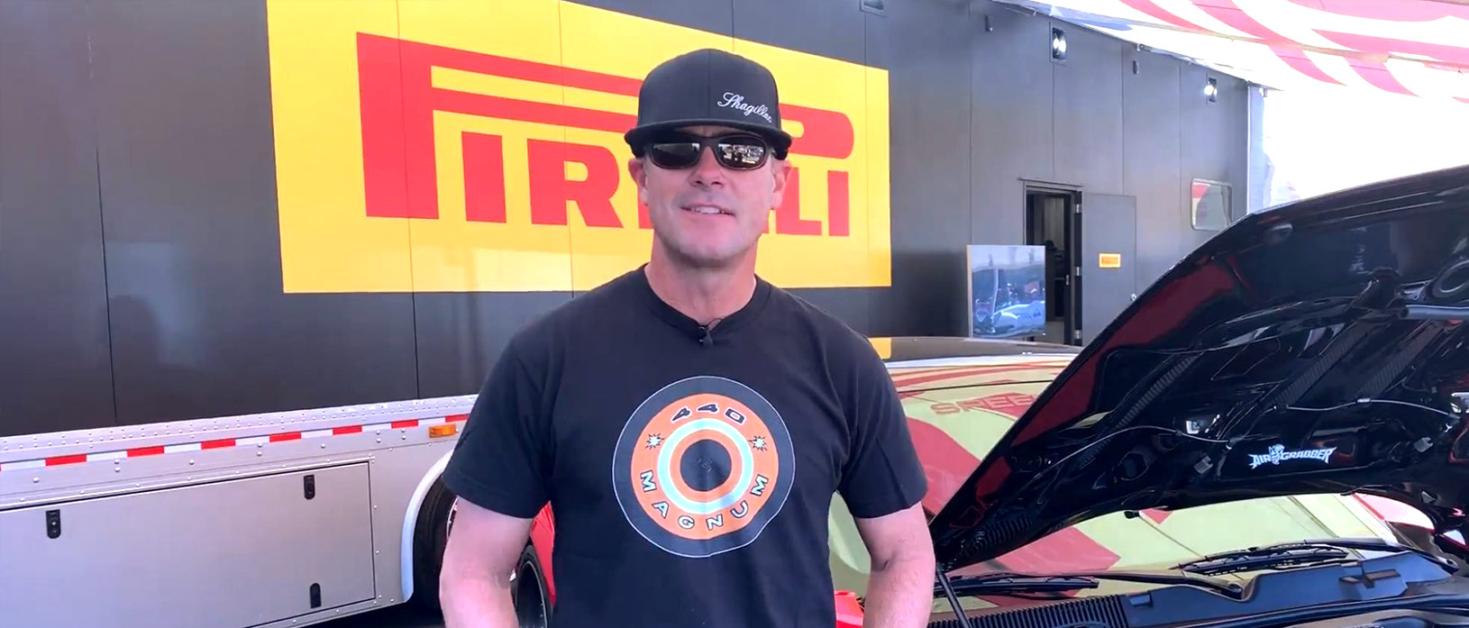 Chris Jacobs at the SEMA show standing in front of SpeedKore carbon fiber body Dodge Demon