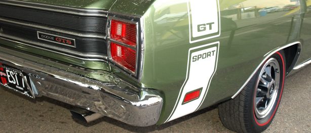 Like every member of the Dodge Scat Pack, the 1969 Dart 440 GTS came standard with a Bumble Bee stripe for quick identification. The sinister red-lettered GTS trunk emblem stands for GT Sport. Note the standard issue chromed exhaust tips, a Package Car first.