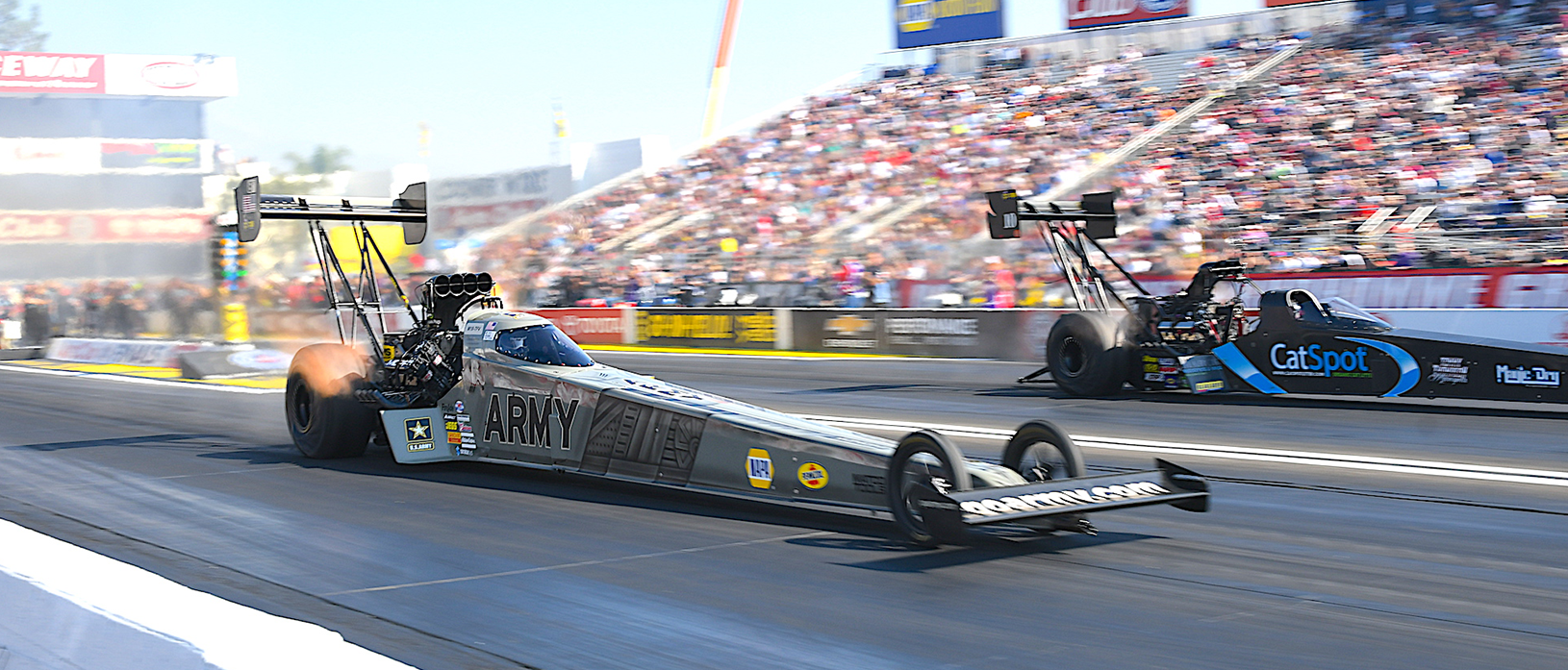 Tony Schumacher's Army Top Fuel dragster racing down the strip
