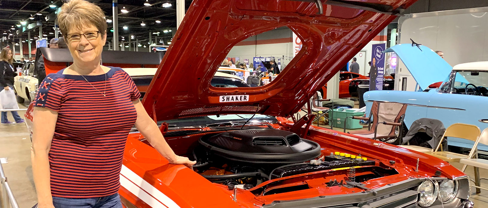 Lena Plymale standing beside her 1971 Dodge Challenger Convertible at MCACN