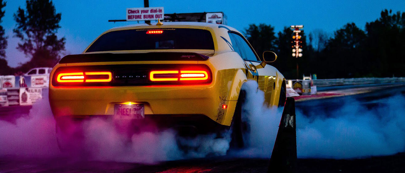 Yellow Dodge Demon doing a burnout