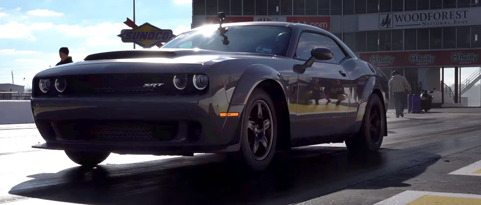 Gray Dodge Demon racing down the track