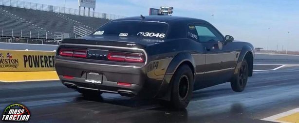 Black Dodge Demon racing down the track