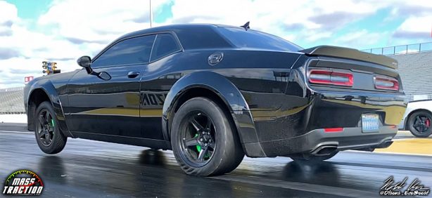 Black Dodge Demon racing down the track