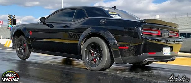 Black Dodge Demon racing down the track