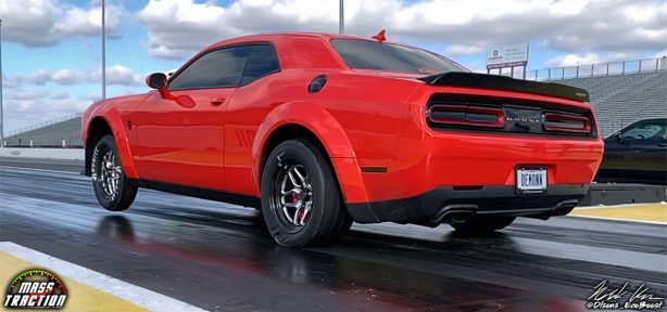 Red Dodge Demon racing down the track