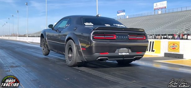 Black Dodge Demon racing down the track