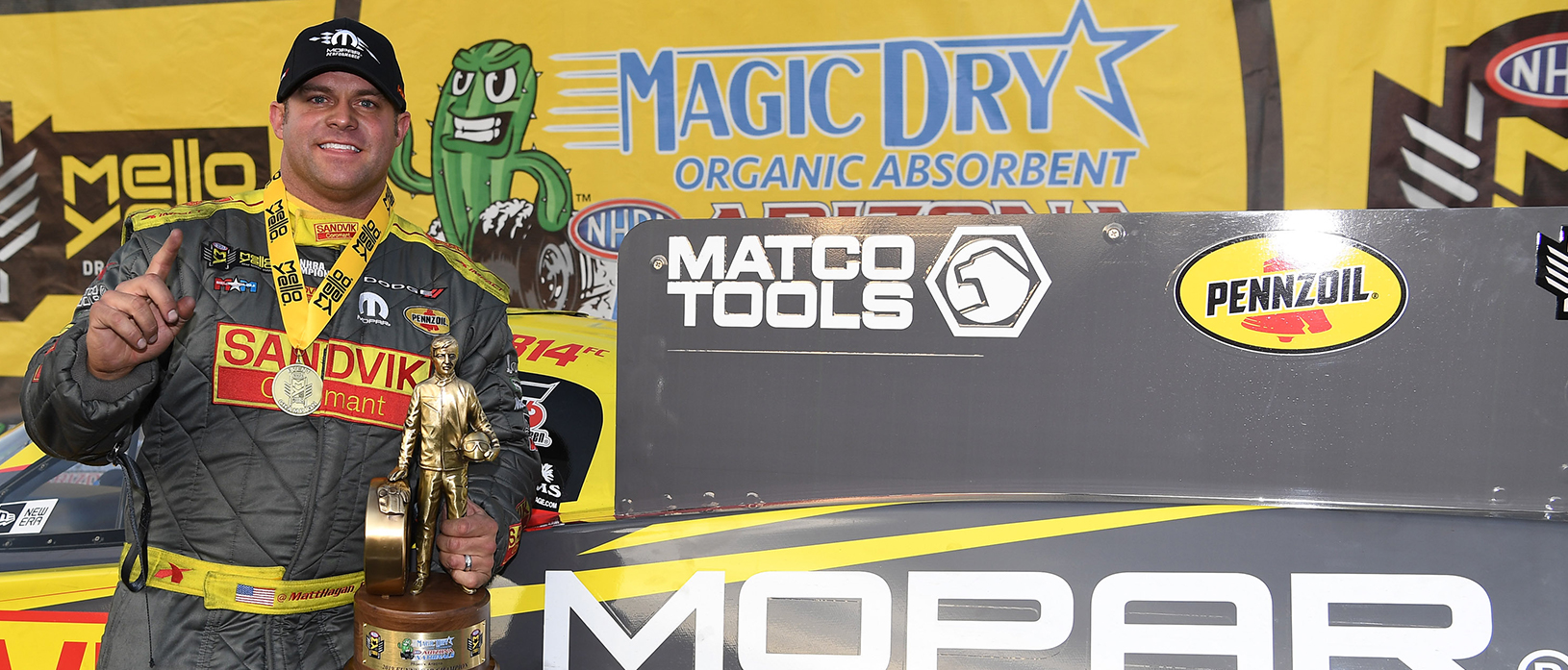 Matt Hagan holding up a Wally trophy after winning NHRA Arizona Nationals