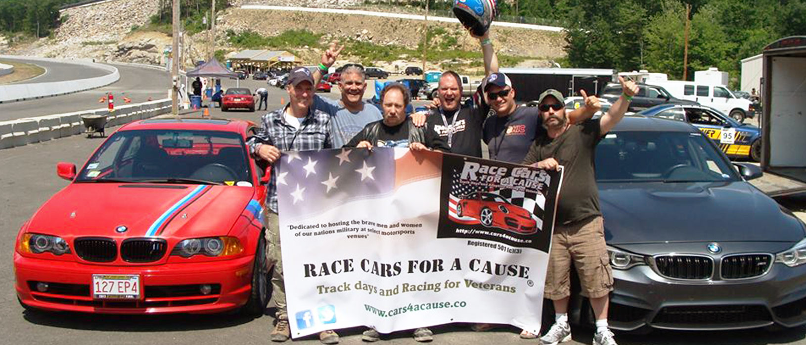 Veterans posing for a picture at Race Cars for a Cause