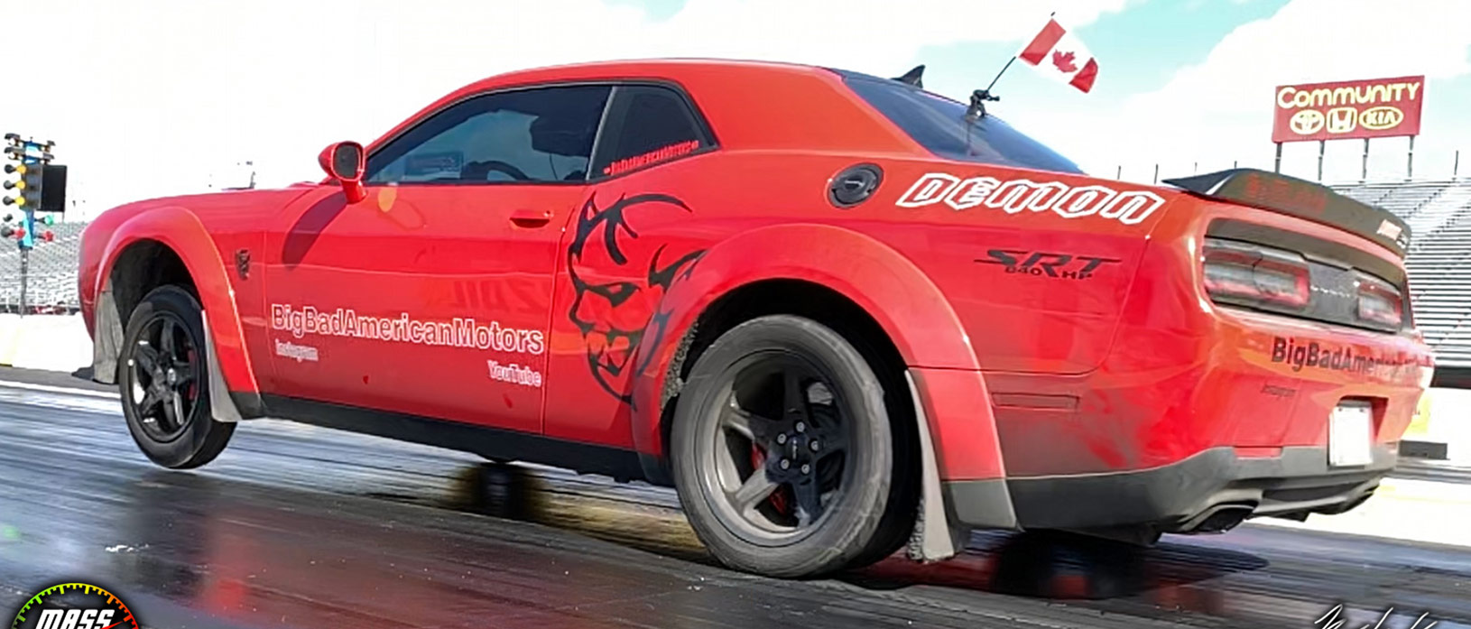 Red Dodge Demon racing down the track