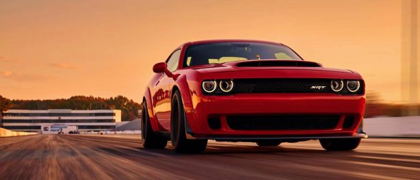 Red Dodge Challenger SRT Demon racing down the track