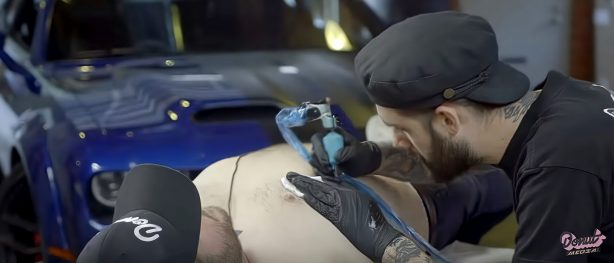James Pumphrey getting "Powered by Dodge" tattoo on his chest