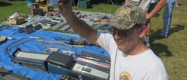 Man holding up a treasure he found at a swap meet