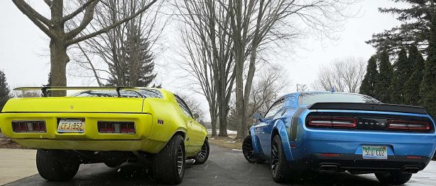 Rear end of yellow GTX and blue Challenger