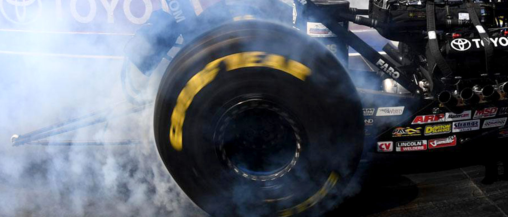 Top Fuel Dragster tire spinning with smoke coming out