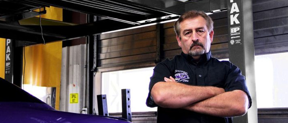 Mark Worman standing beside purple car