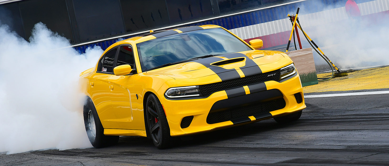 Yellow Charger Hellcat doing a burnout