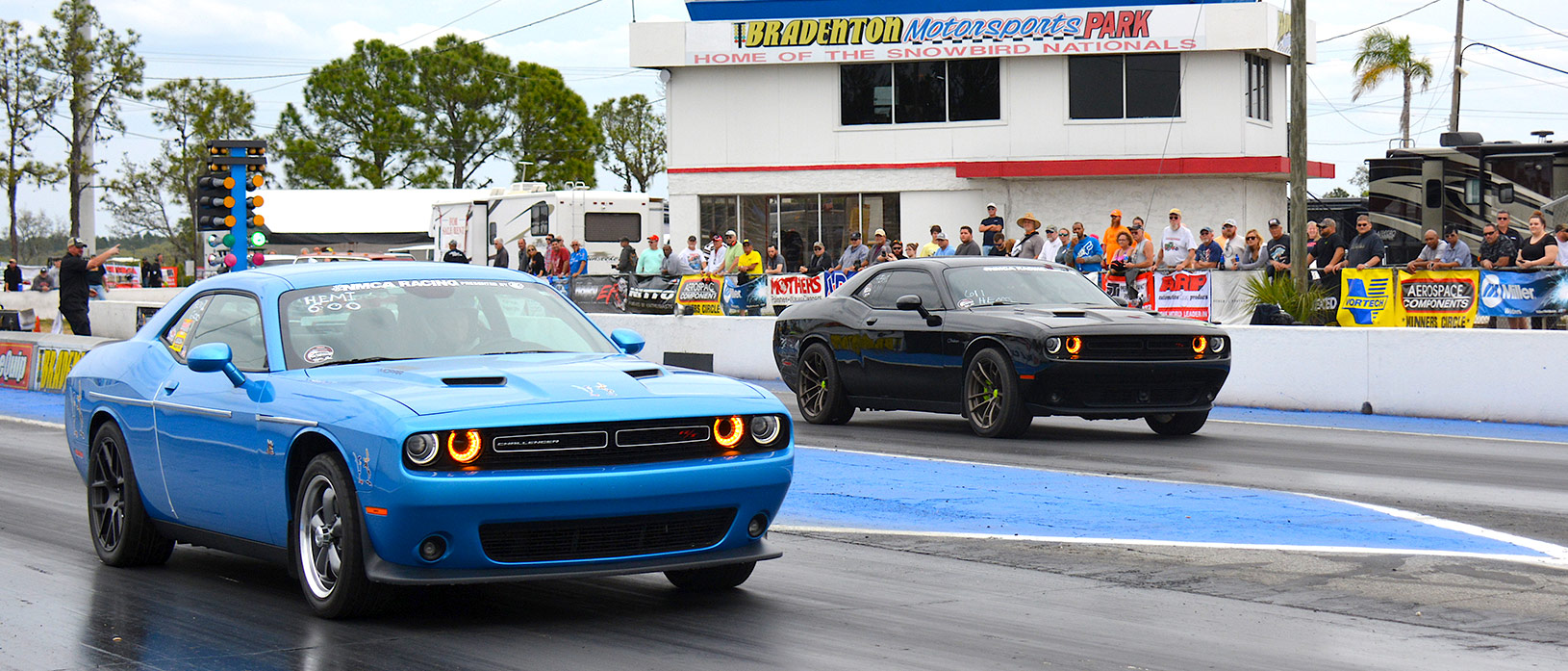 Black Challenger racing a blue challenger at NMCA