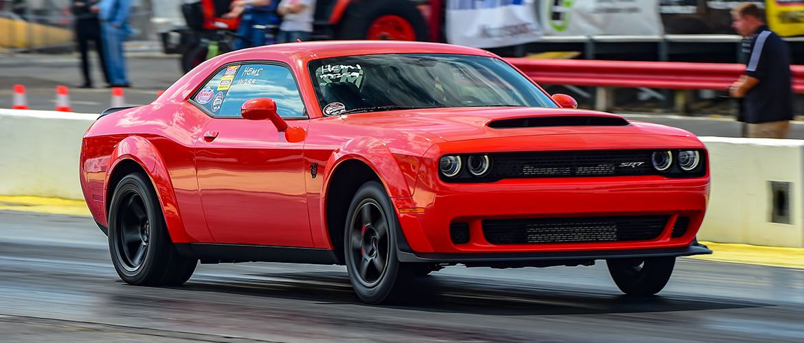 Red Challenger racing down the track