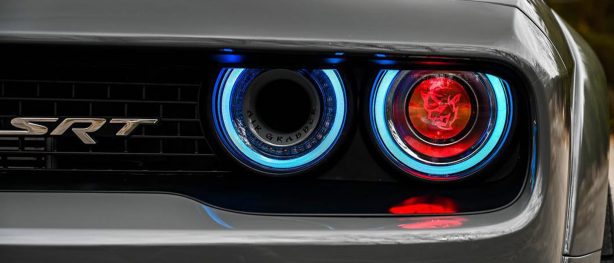 Headlights of a Dodge Demon with a Demon head in the center