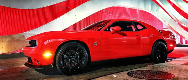 Red Challenger 1320 Drag Pak in front of a red and white wavey wall