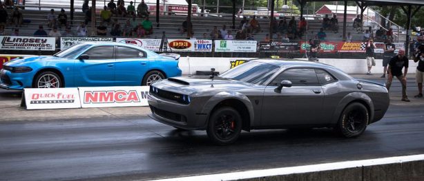 Gray Dodge Demon racing a blue Charger Hellcat