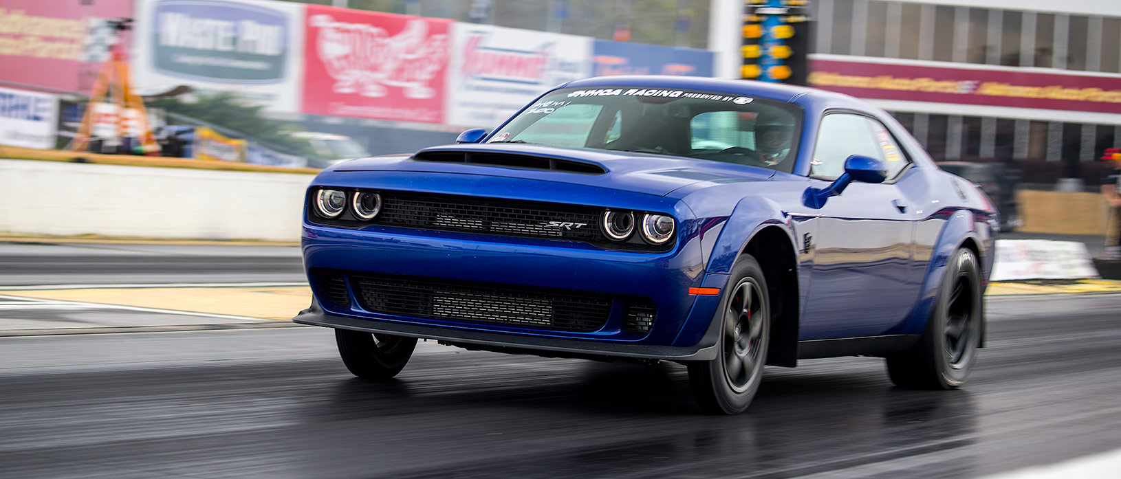 Blue Challenger SRT racing down the track
