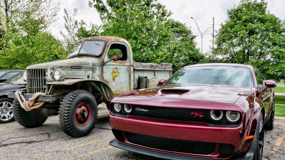 Red Challenger R/T next to vintage Dodge truck