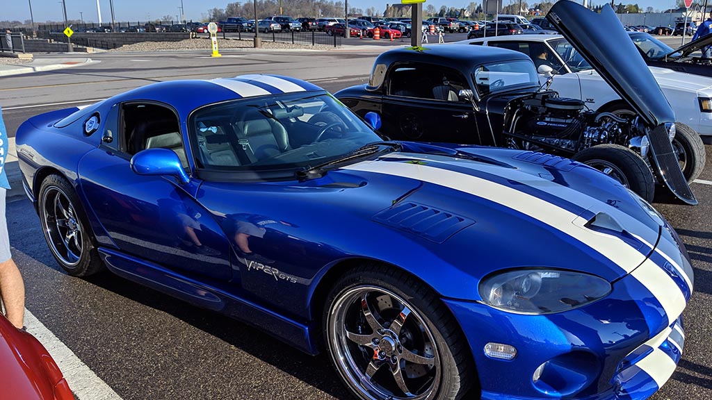 Rows of cars and crowds of people at Cars & Coffee Minnesota