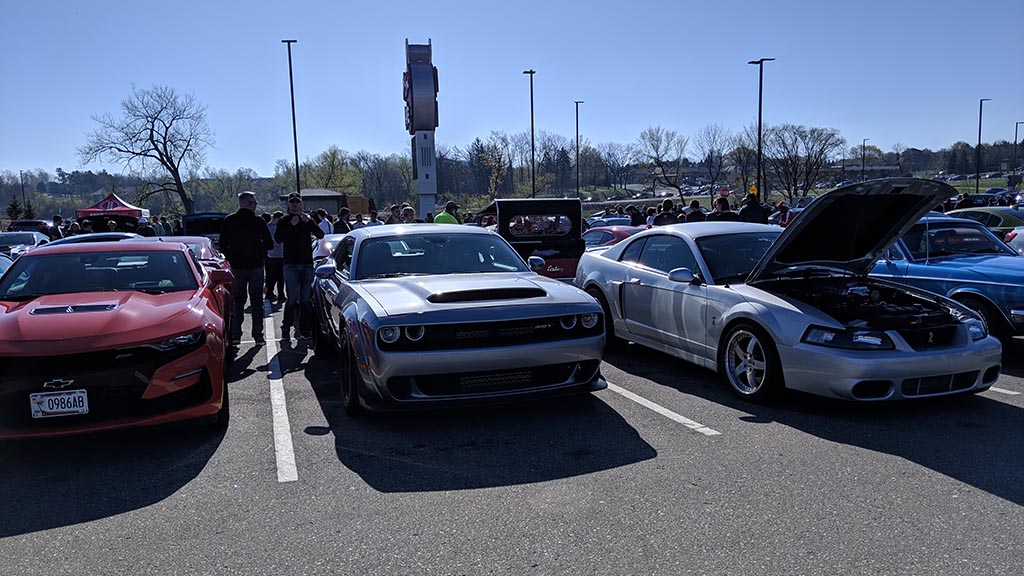 Rows of cars and crowds of people at Cars & Coffee Minnesota