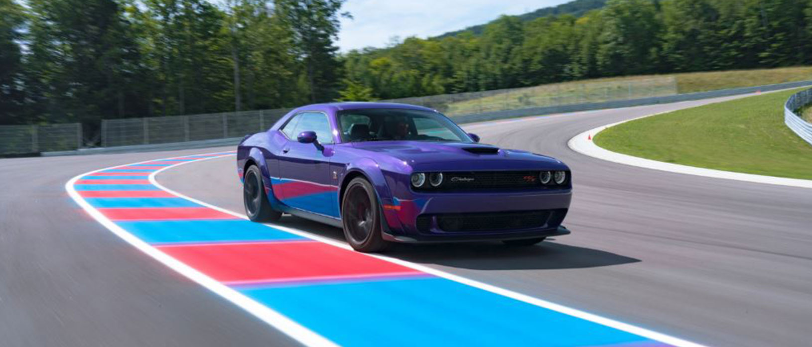 Plum Crazy Scat Pack Challenger driving on a road course