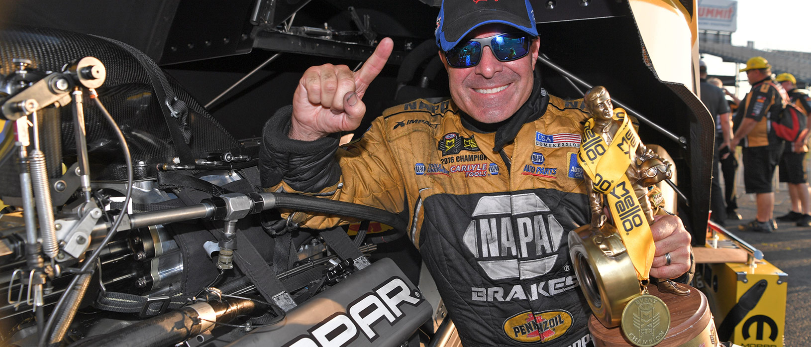 Ron Capps holding up his Wally trophy after winning the NHRA Virginia Nationals