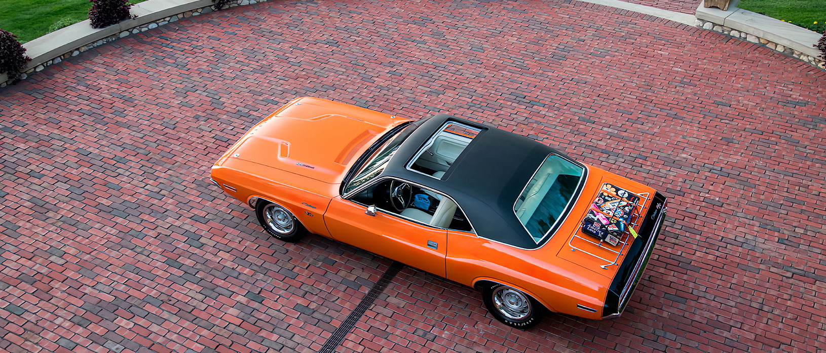 Orange 1970 Dodge Challenger with black top and sunroof