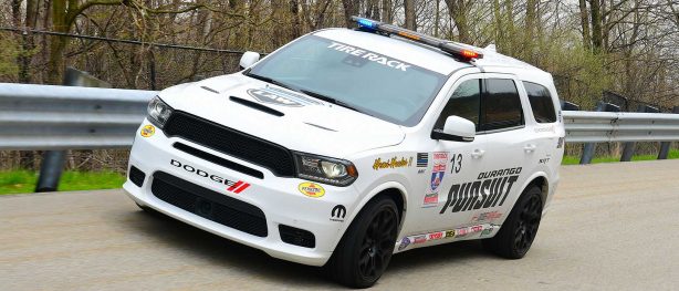 White Dodge Durango SRT Pursuit with race decals driving around a track