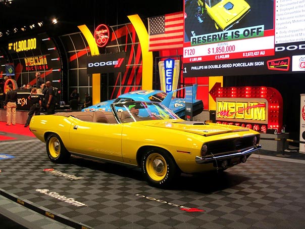 side view of a yellow dodge challenger convertable in a show with the top down