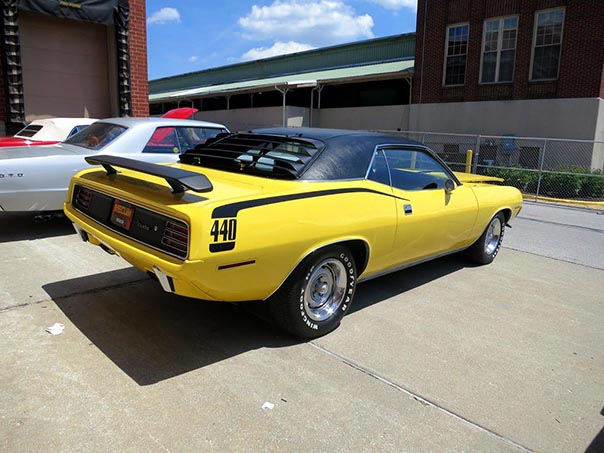 Rear side view of a yellow 440 challenger convertable.