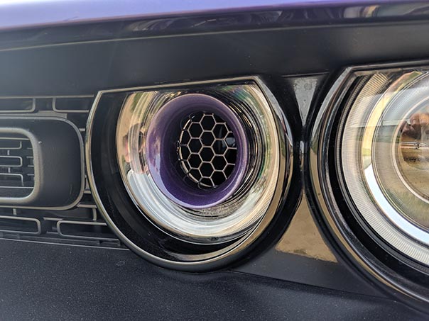 Headlight of Plum Crazy Challenger at Mopars in the Park