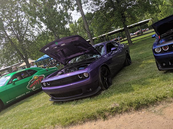 Plum Crazy Challenger with the hood open at Mopars in the Park
