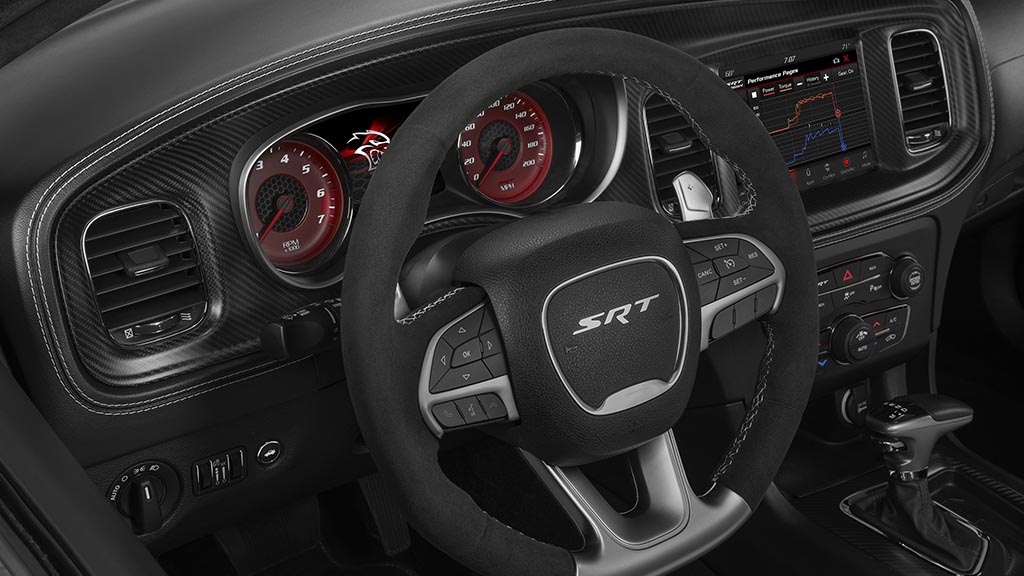 The race-inspired interior of the Dodge Charger SRT Hellcat Widebody features a standard, leather-wrapped SRT flat-bottom steering wheel with mounted controls and paddle shifters, and standard French live-stitch accents throughout the instrument panel and doors