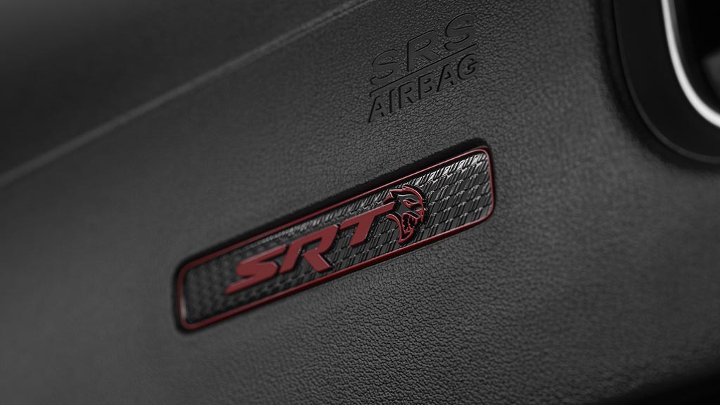 The 2020 Dodge Charger SRT Hellcat Widebody features a new SRT Hellcat instrument panel badge, uniquely customized for the model year with a black and red finish