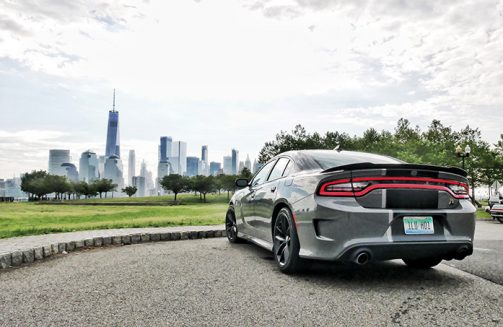 a gray dodge charger facing the new work city skyline