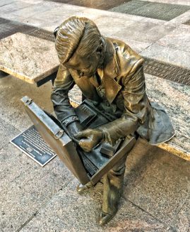 a bronze statue of a man with a briefcase