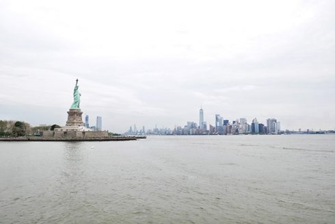 the statue of liberty and the city skyline in the background